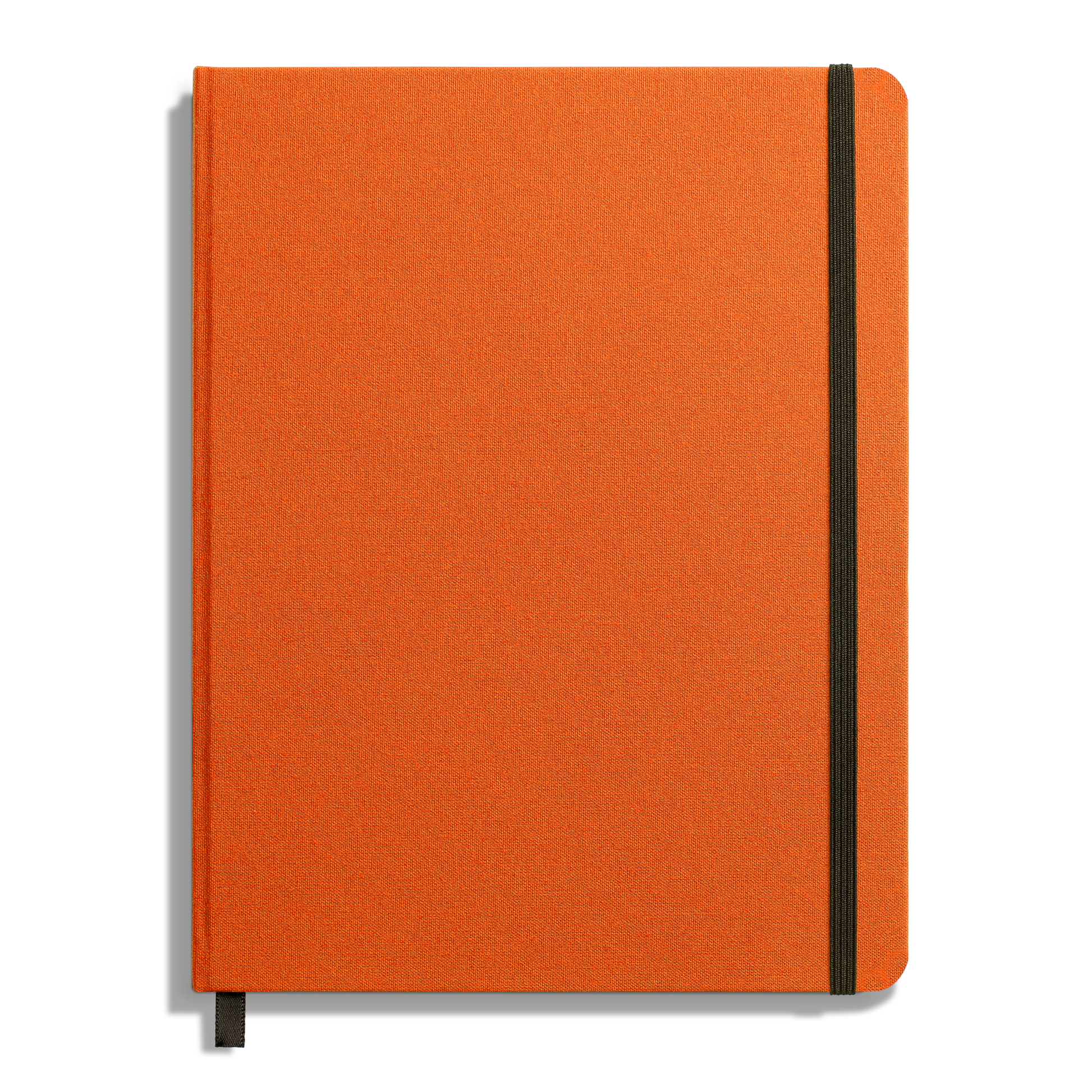 The Shinola Large Hard Ruled Journal in Bold Orange features a closed hard linen cover, a vertical black elastic band on the right side, and a black ribbon bookmark at the bottom edge.