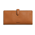The Shinola Continental Snap Wallet - Tan is made from natural leather, featuring a slim design, flap with snap closure, and Shinola embossed on the front center. Shown against a plain white background.
