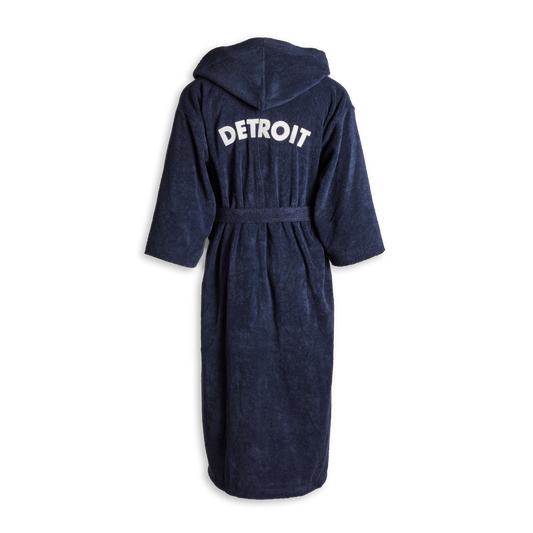 The Shinola Hotel Detroit Robe - Navy by Shinola is an ultra-plush cotton bathrobe with a belt, shown from the back, featuring "DETROIT" in bold white letters across the upper back.