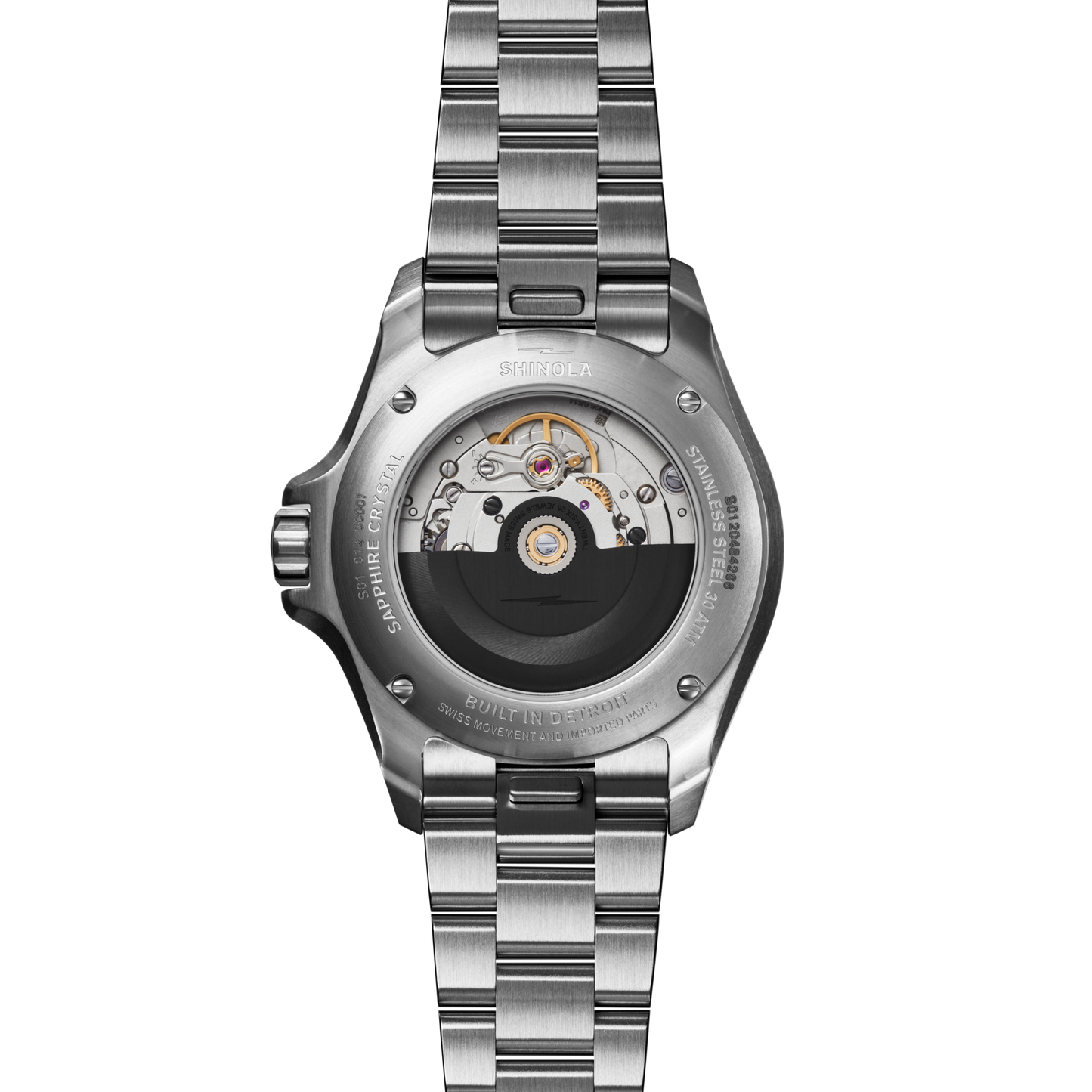 The image displays the back of the Shinola Lake Ontario Monster Automatic Dive Watch – Lake Ontario, featuring a stainless steel, brushed bracelet and case with a transparent back that reveals its intricate automatic movement.