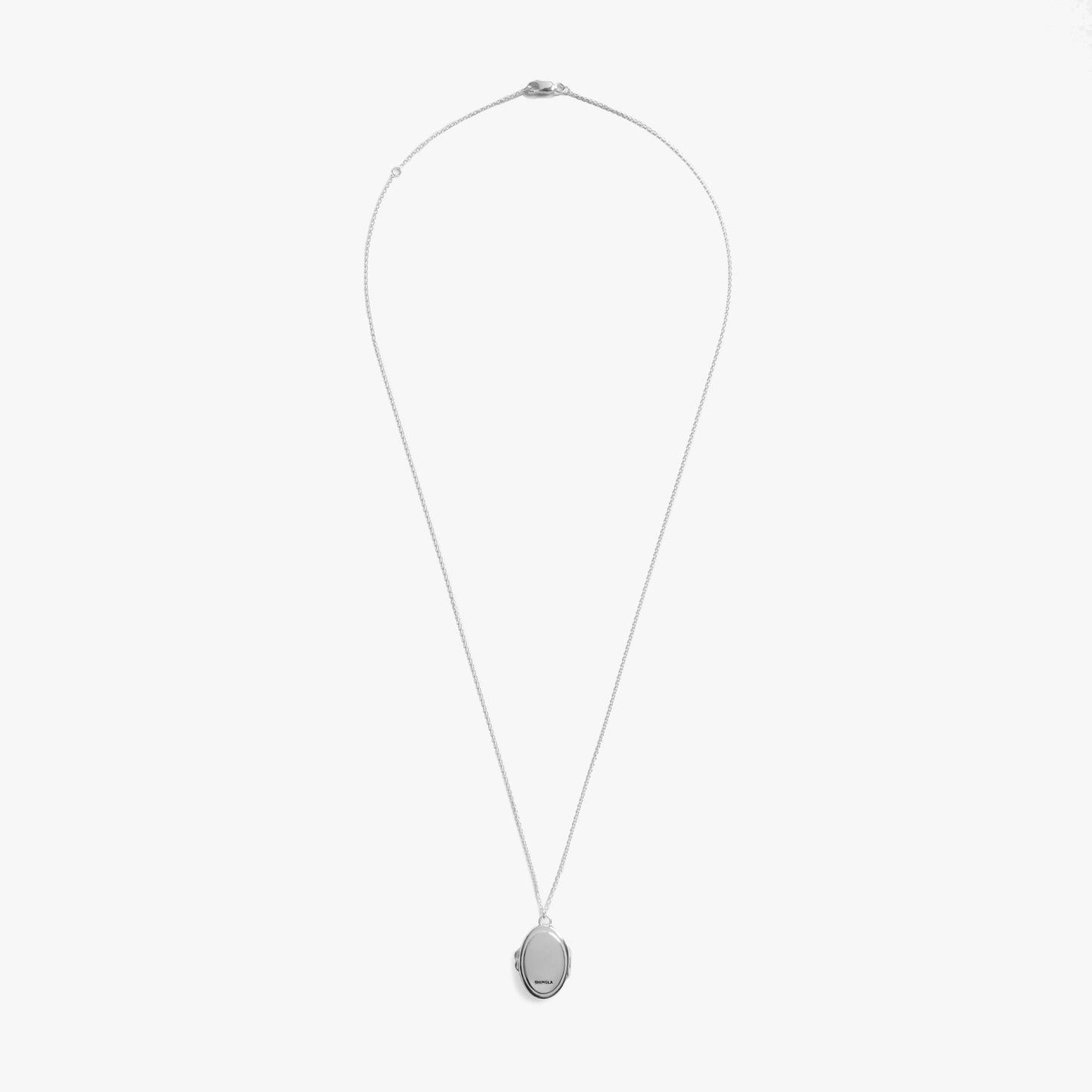 The Shinola Heirloom Statement Locket Necklace features a sterling silver thin chain and an oval, engravable pendant, shown on a plain white background.