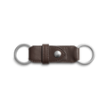 The Shinola Leather Valet Key Fob in dark brown features a central metal snap button and two silver key rings at each end, shown against a white background.