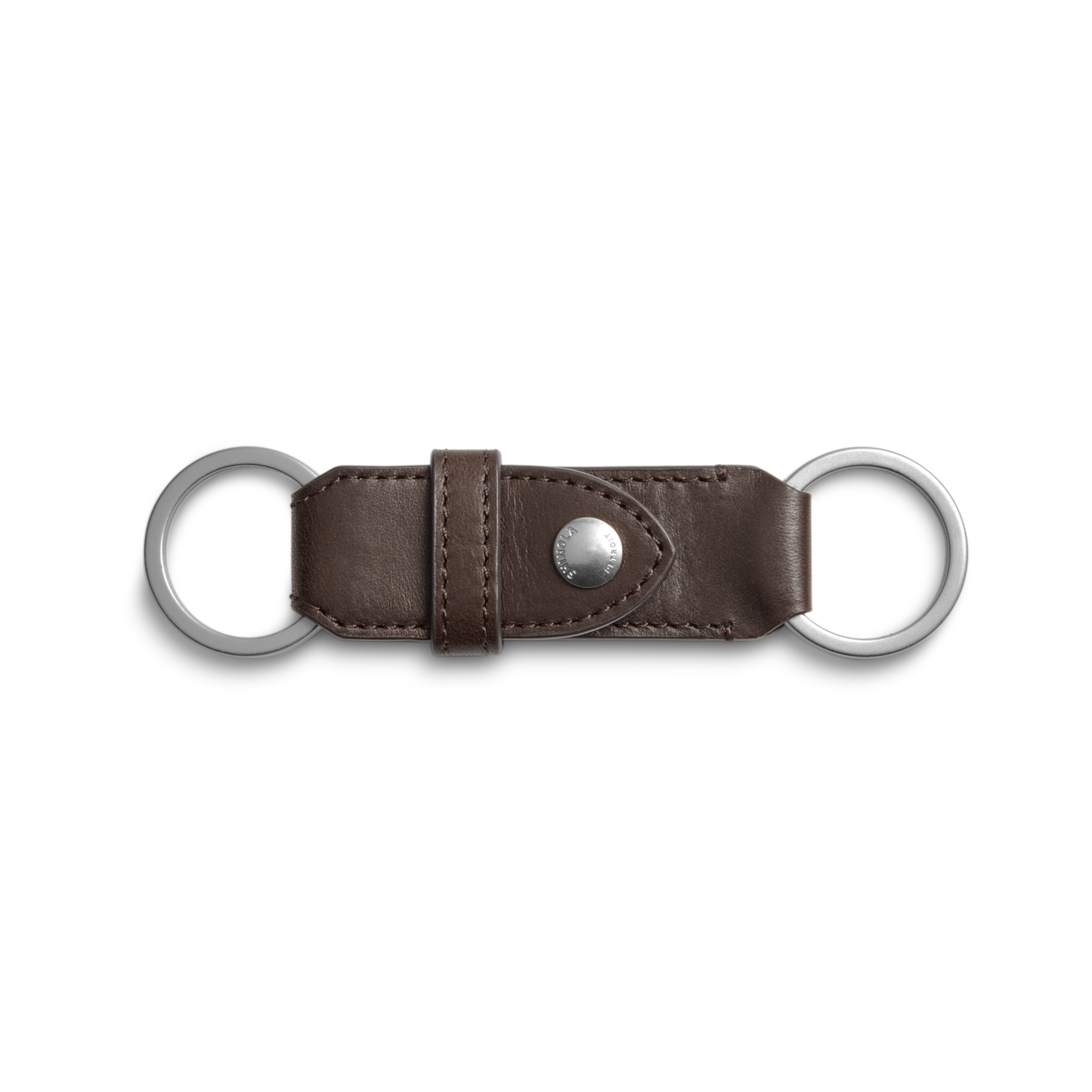 The Shinola Leather Valet Key Fob in dark brown features a central metal snap button and two silver key rings at each end, shown against a white background.