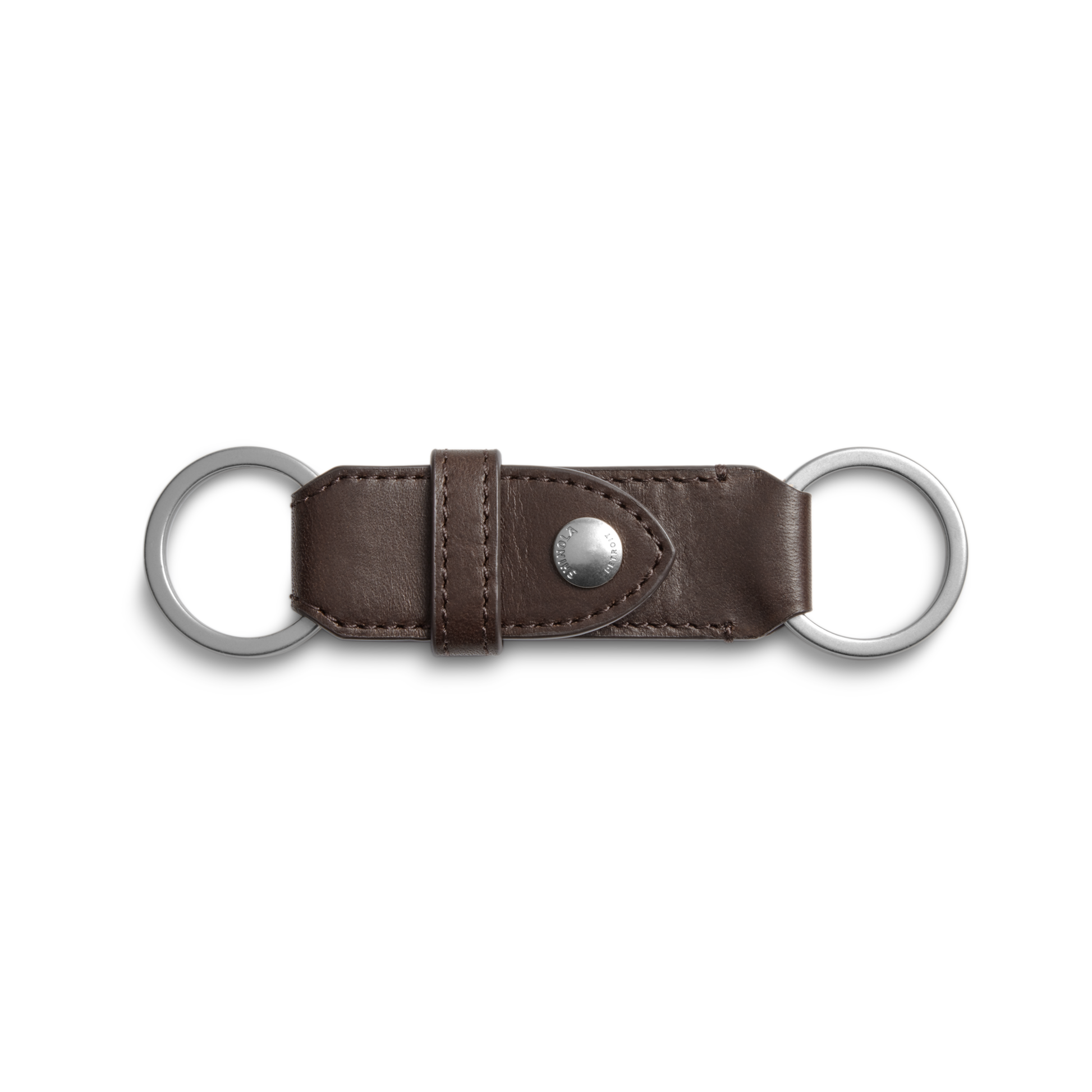 The Shinola Leather Valet Key Fob in dark brown features a central metal snap button and two silver key rings at each end, shown against a white background.
