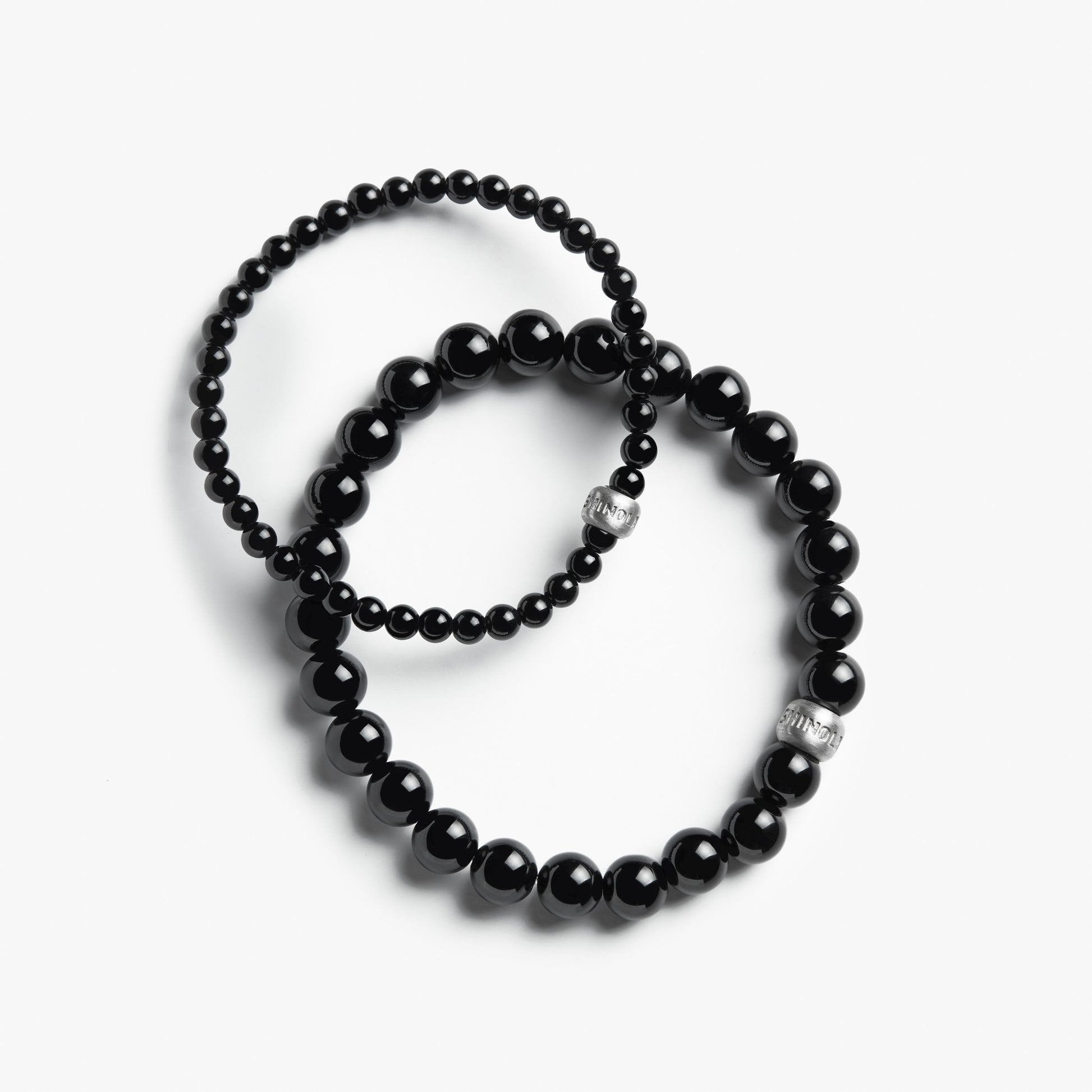 Two Shinola bracelets—a beaded 8mm Onyx bracelet and a second with smaller beads—are displayed on a white background.