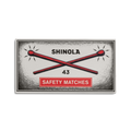 A vintage-style Shinola 4" Safety Matches box features two red matches crossing under "SHINOLA," the number 43 below, and comes in an orange aluminum matchbox sleeve labeled "SAFETY MATCHES.