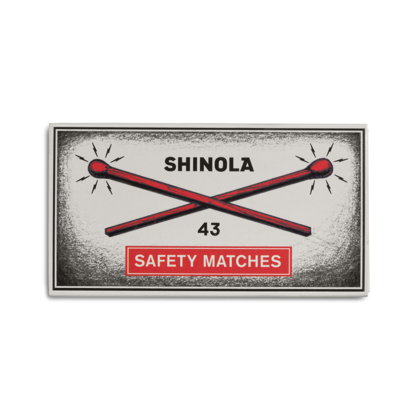 A vintage-style Shinola 4" Safety Matches box features two red matches crossing under "SHINOLA," the number 43 below, and comes in an orange aluminum matchbox sleeve labeled "SAFETY MATCHES.