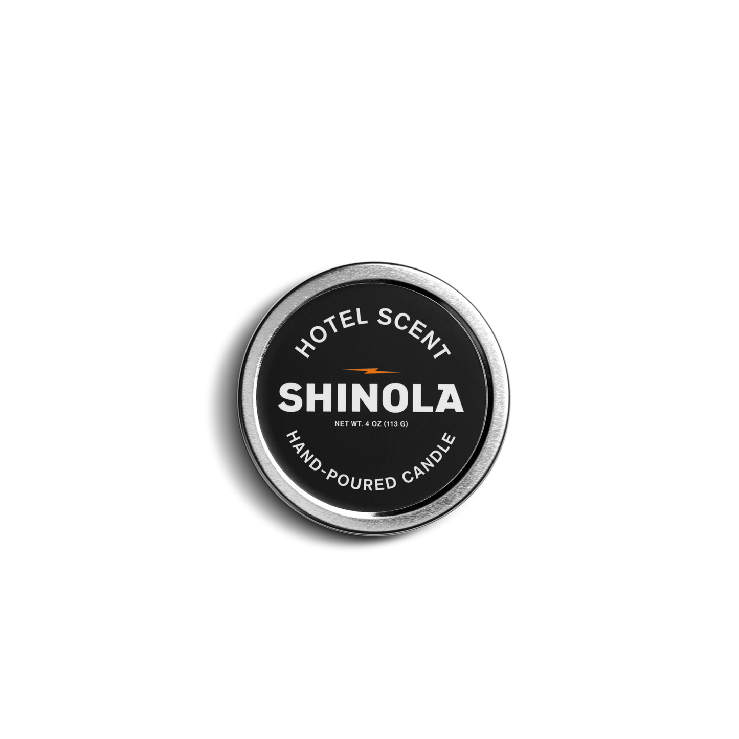 Photographed from above, the Shinola Hand Poured 4oz Travel Candle – Hotel has a round tin with a black label and white text; its coconut soy wax offers a clean, long-lasting burn in a portable design.