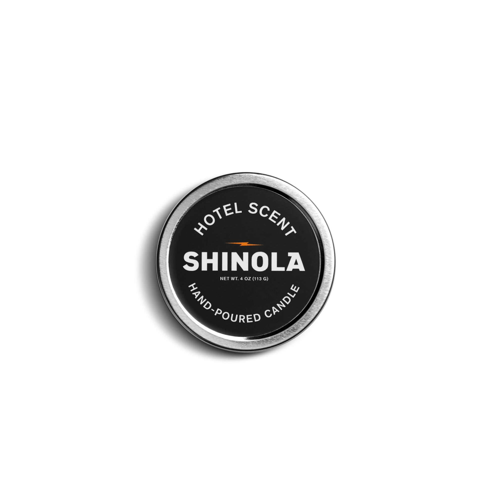 Photographed from above, the Shinola Hand Poured 4oz Travel Candle – Hotel has a round tin with a black label and white text; its coconut soy wax offers a clean, long-lasting burn in a portable design.