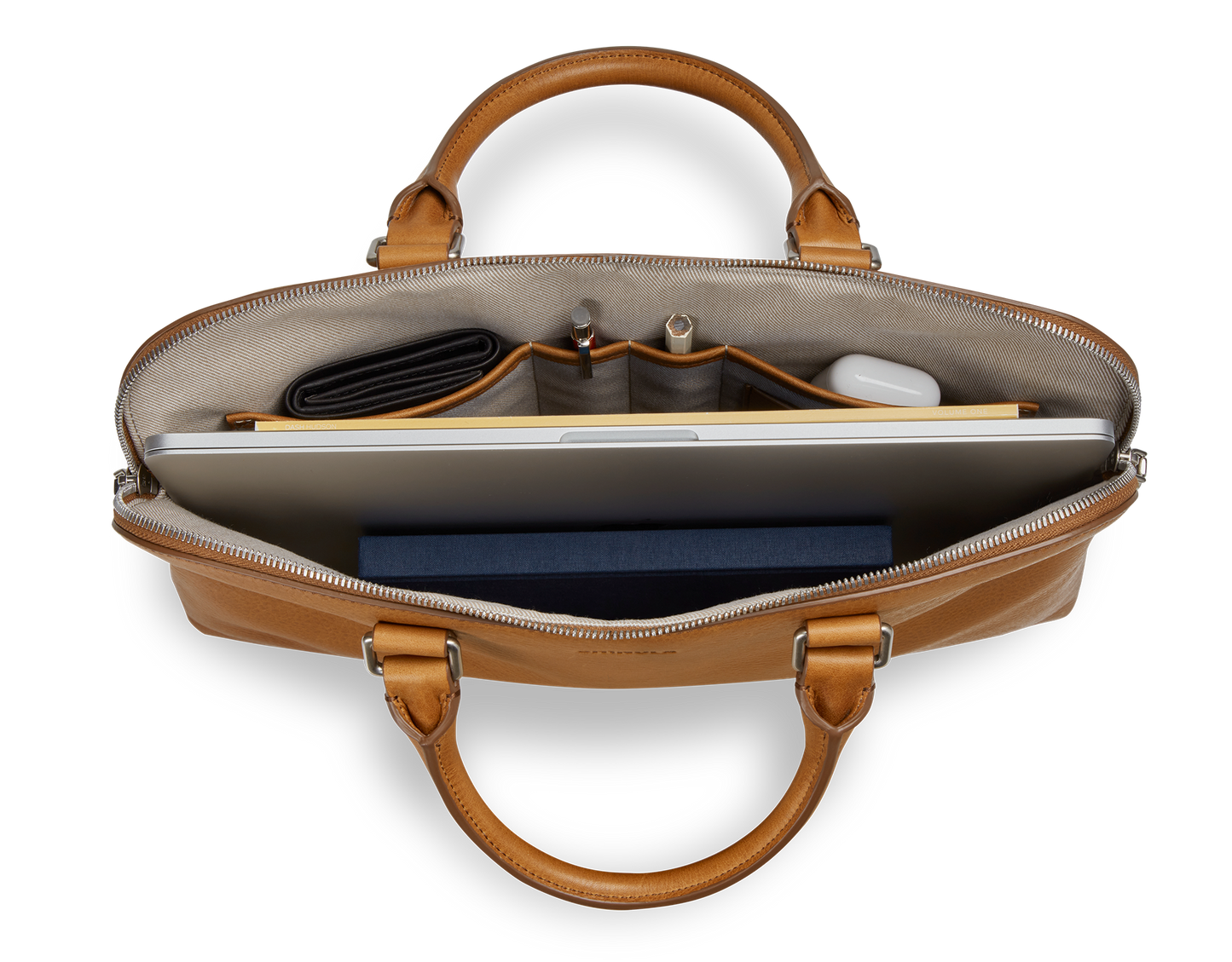 Top view of the Shinola Portfolio Briefcase - Tan, showcasing a laptop, wallet, pens, notebook, and wireless earbuds neatly organized in its compartments.