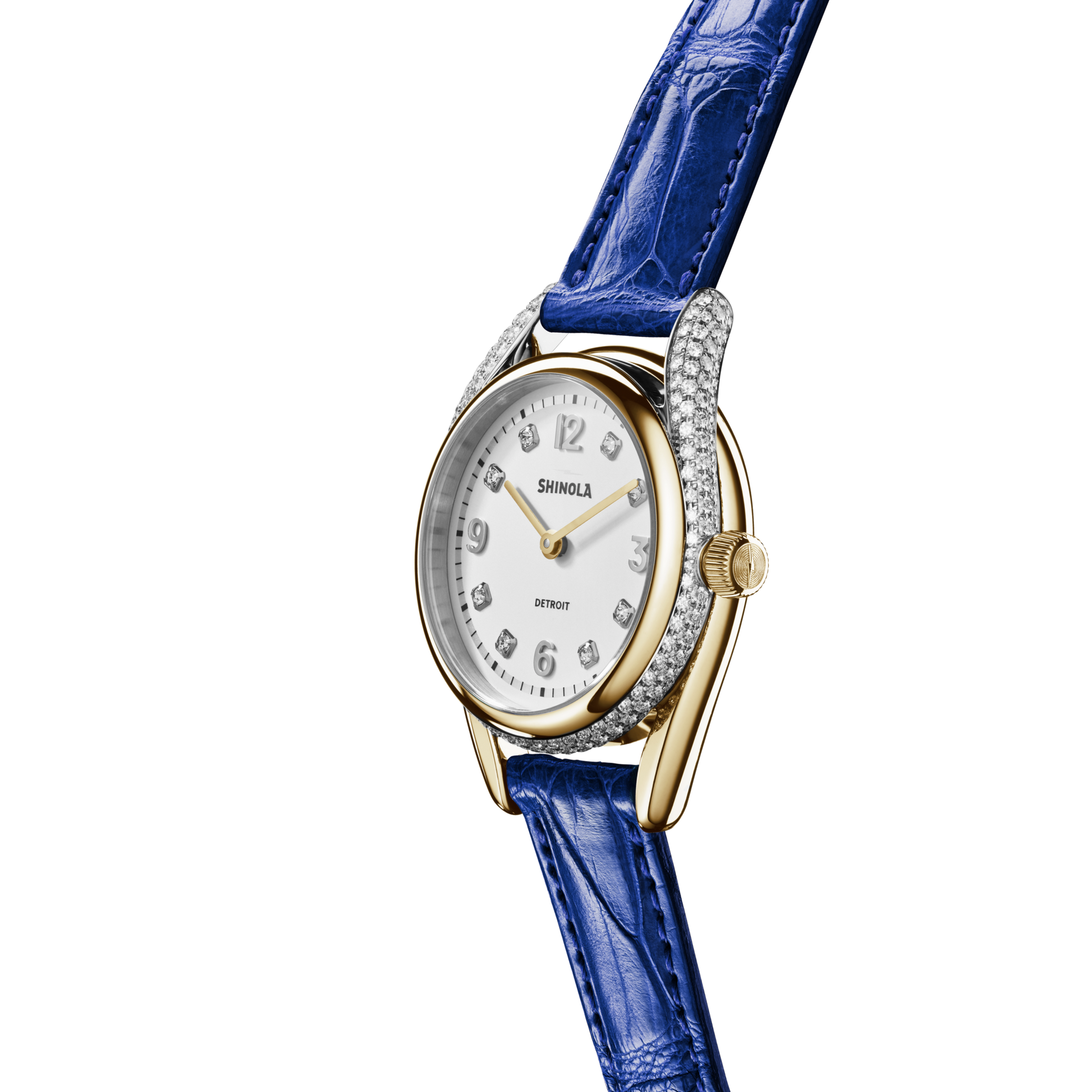 The Shinola Diamond Derby Watch features a two-tone gold and silver case, white dial with Arabic numerals, diamond-encrusted bezel, gold hour and minute hands, and a blue sapphire alligator strap. Displayed on a plain white background.