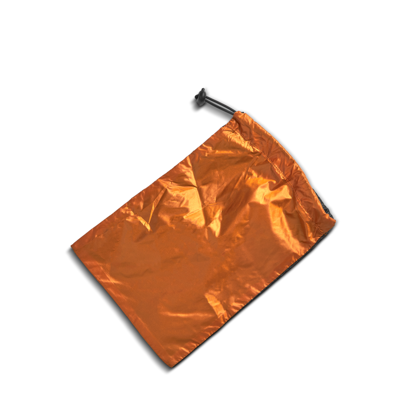 A Shinola Reversible Puffer Dog Coat in orange and black lies on a white background, its cozy, crinkled material and partially-pulled drawstring with a black toggle resembling a stylish, warm dog jacket.