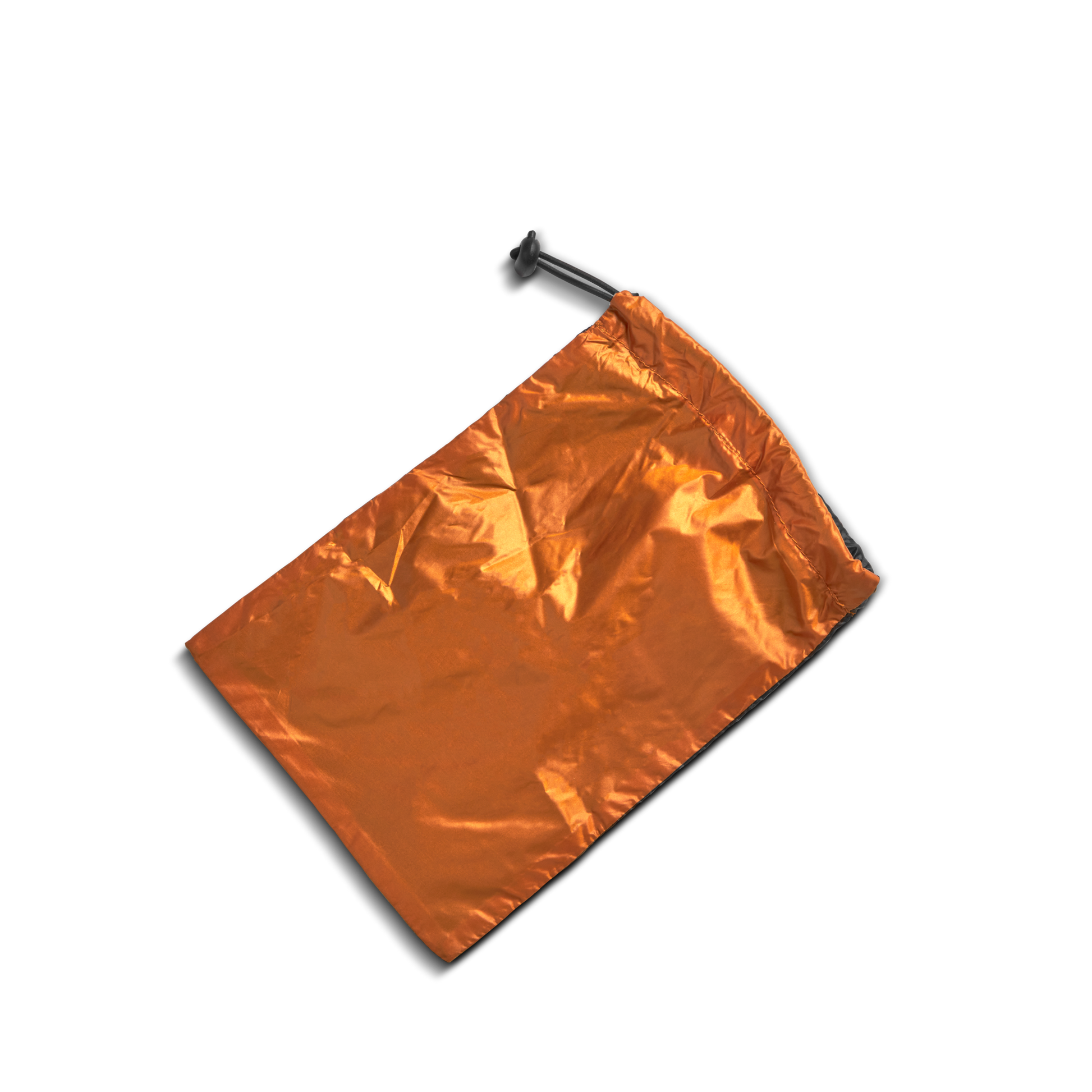 A Shinola Reversible Puffer Dog Coat in orange and black lies on a white background, its cozy, crinkled material and partially-pulled drawstring with a black toggle resembling a stylish, warm dog jacket.