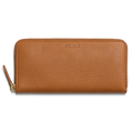 The Shinola Continental Zip Wallet - Tan is crafted from natural grain leather with a textured finish, features embossed branding at the top center, multiple interior card pockets, and a zipper with a matching leather pull tab.