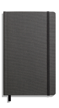 The Shinola Medium Soft Ruled Journal in charcoal, featuring a fabric-textured gray hardcover, elastic right-edge closure, and black ribbon bookmark, rests on a plain white background.