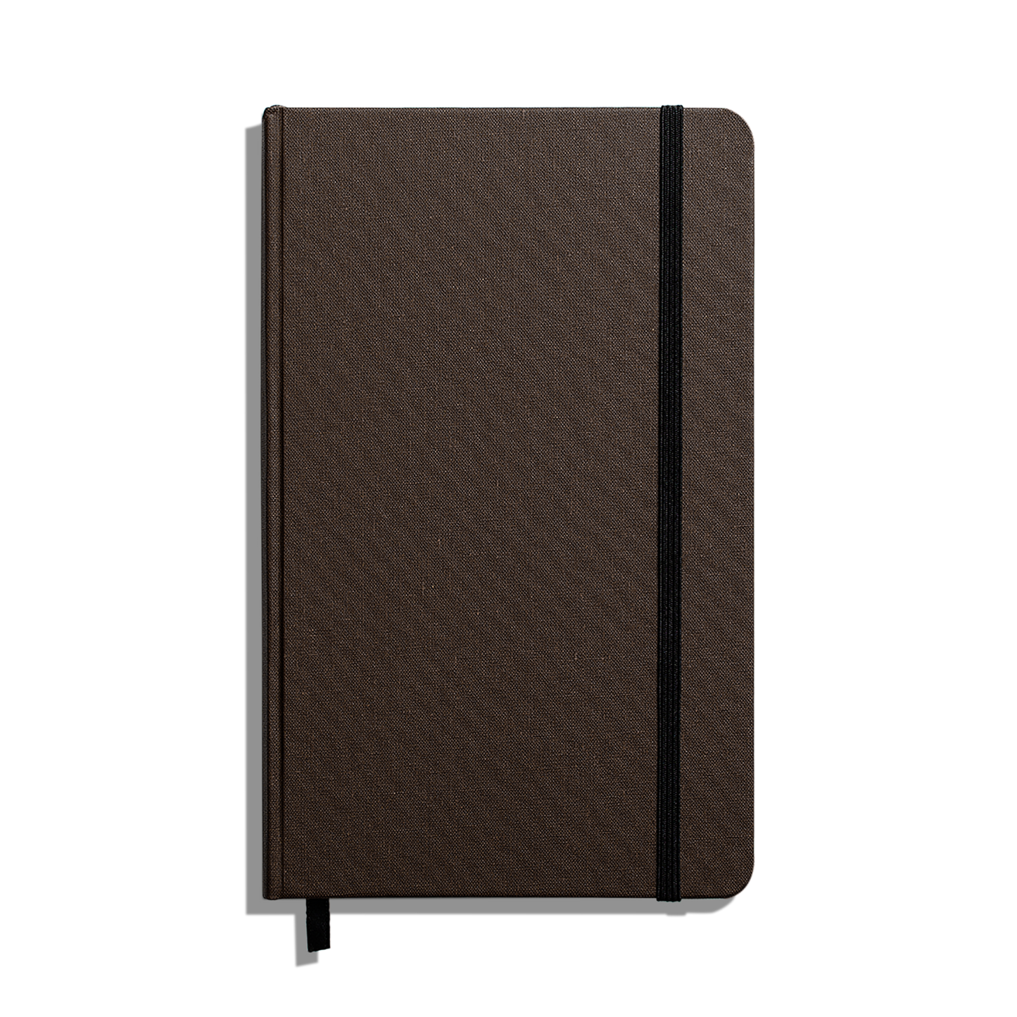 The Shinola Medium Hard Ruled Journal (5.25" x 8.25") is a closed brown hardcover notebook with rounded corners, a black elastic band, acid-free paper, and a black ribbon bookmark, displayed on a white background.