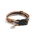 The Shinola Nylon Dog Collar - Brand Stripe features orange, navy, and white stripes, a black Shinola Detroit buckle, silver ring, brown leather patch accent, and a round silver tag.