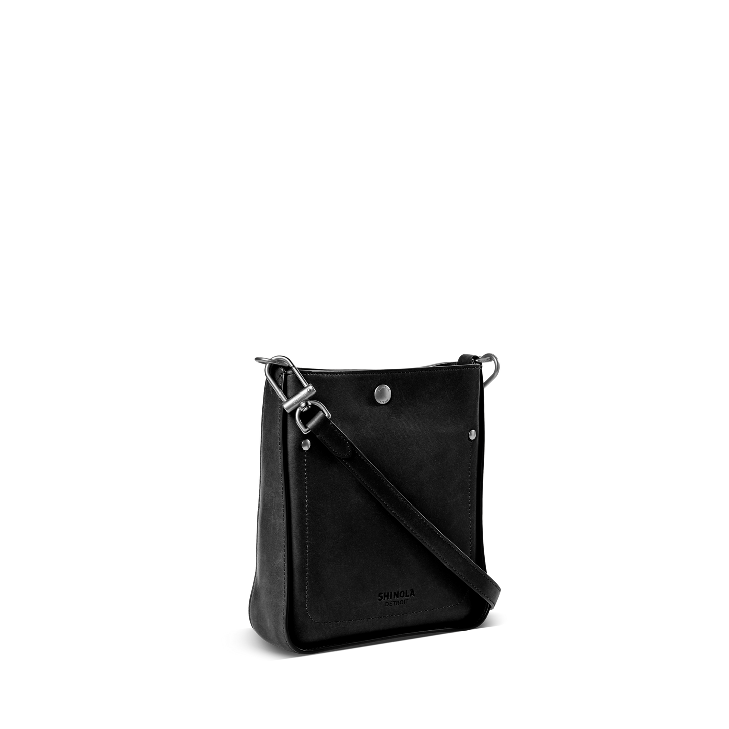 The Shinola Mini Pocket Crossbody Bag in black leather features a front pocket, silver hardware, and an adjustable strap, shown on a plain white background.