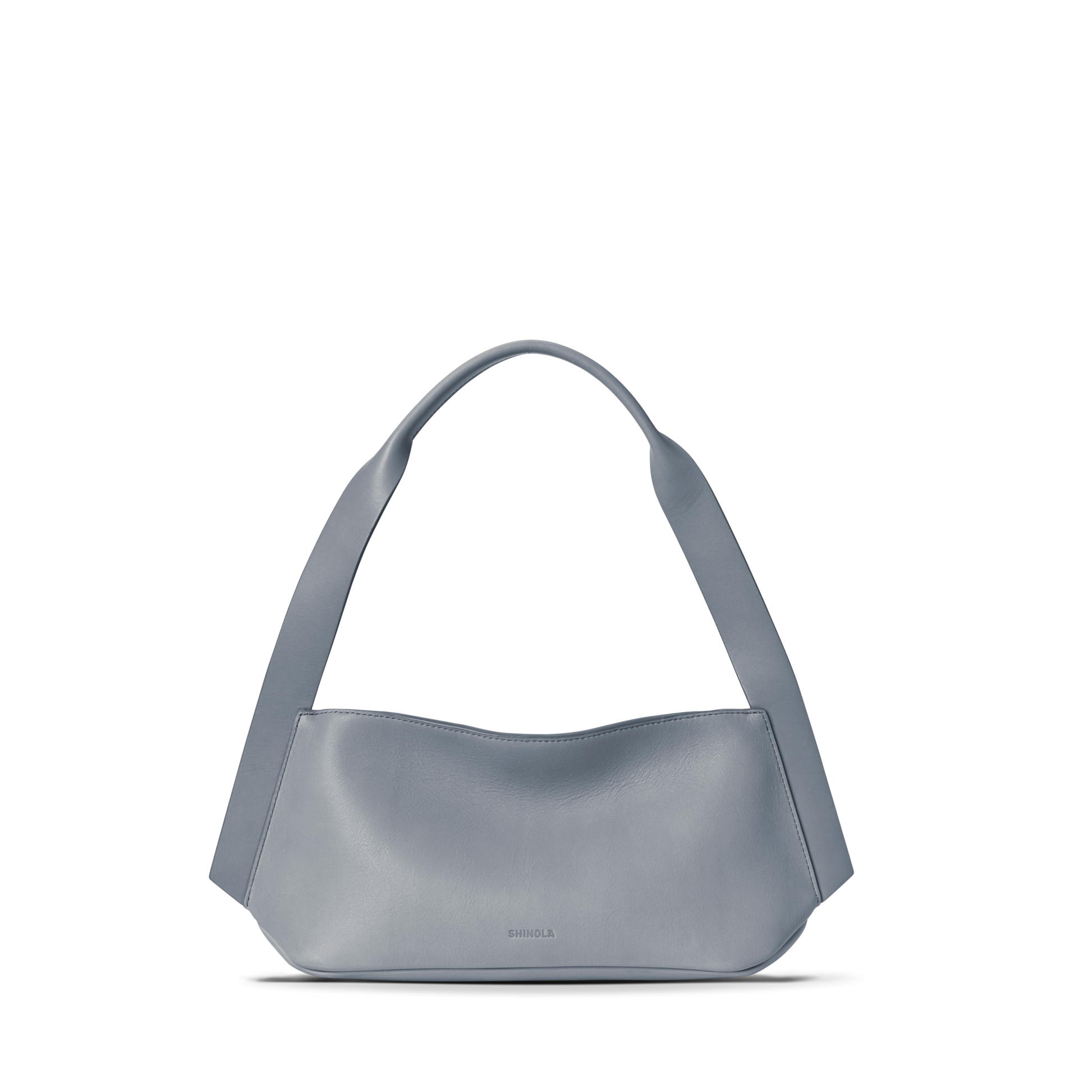 The Shinola Small Derby Shoulder Bag - Mist is a minimalist light blue petite shoulder bag crafted from natural leather, with a wide, curved strap, smooth structured body, and subtle embossed logo near the bottom center. Displayed on a white background.