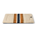 The Shinola Crate Comfort Mat - Oat Stripe is a rectangular beige shearling Berber dog mat with two wide brown and one wide dark blue stripe, machine washable and ideal as a stylish dog crate cushion. Shown on a white background.