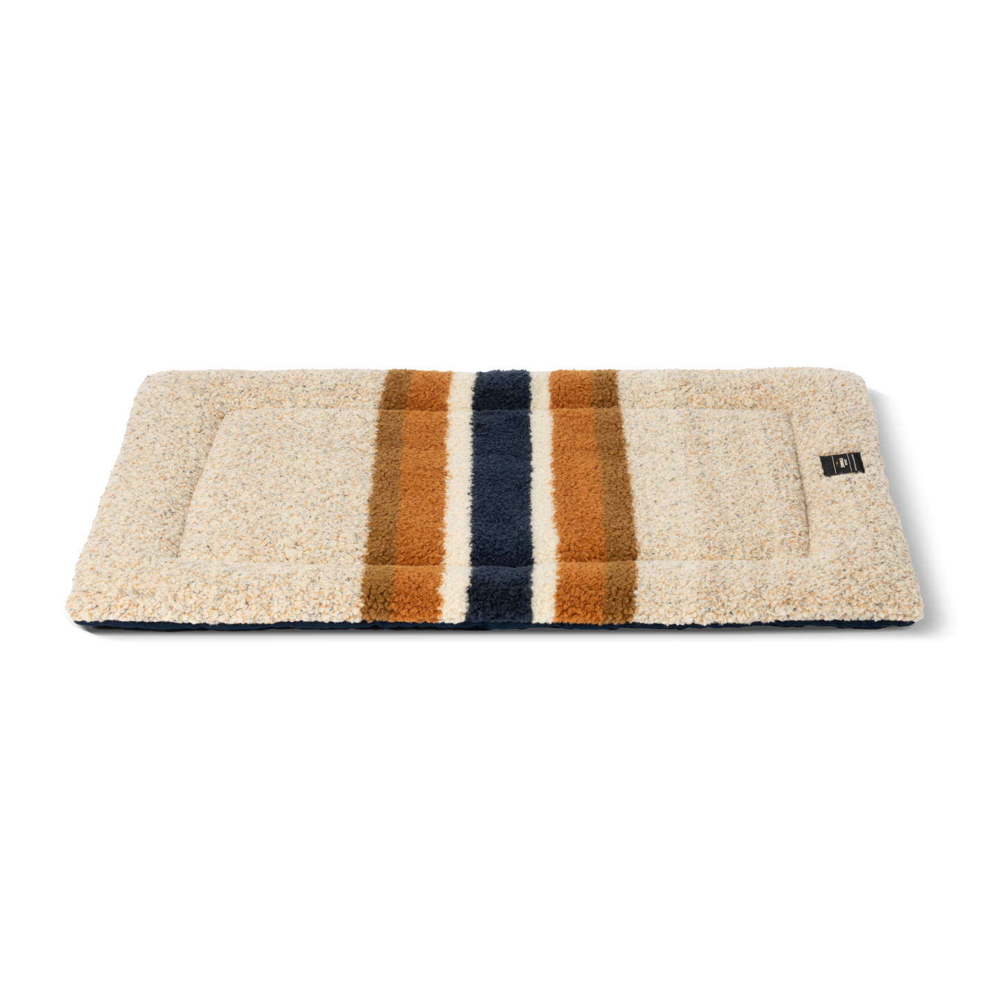 The Shinola Crate Comfort Mat - Oat Stripe is a rectangular beige shearling Berber dog mat with two wide brown and one wide dark blue stripe, machine washable and ideal as a stylish dog crate cushion. Shown on a white background.