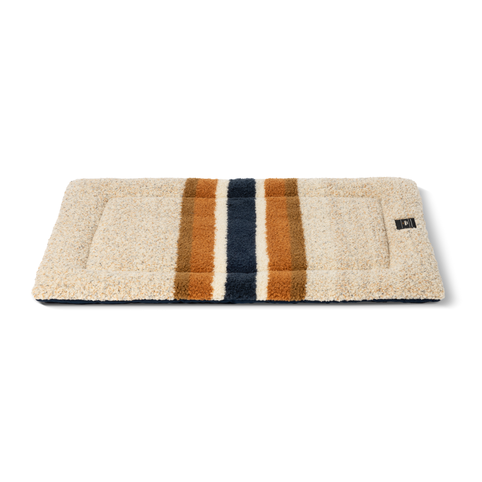 The Shinola Crate Comfort Mat - Oat Stripe is a rectangular beige shearling Berber dog mat with two wide brown and one wide dark blue stripe, machine washable and ideal as a stylish dog crate cushion. Shown on a white background.