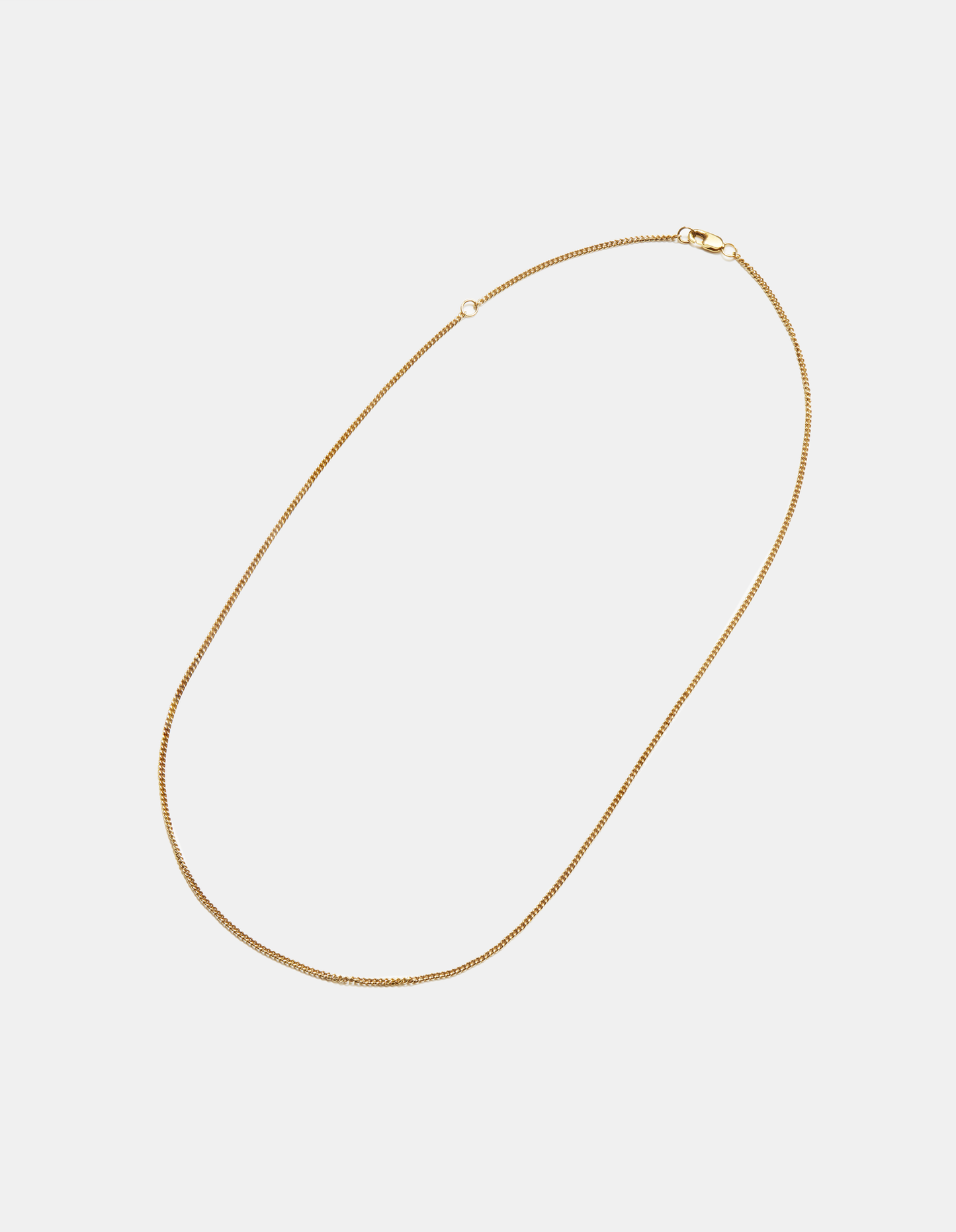 The Shinola Small Curb Link necklace features a thin, small 14k yellow gold curb chain with a discreet clasp, shown on a plain white background.