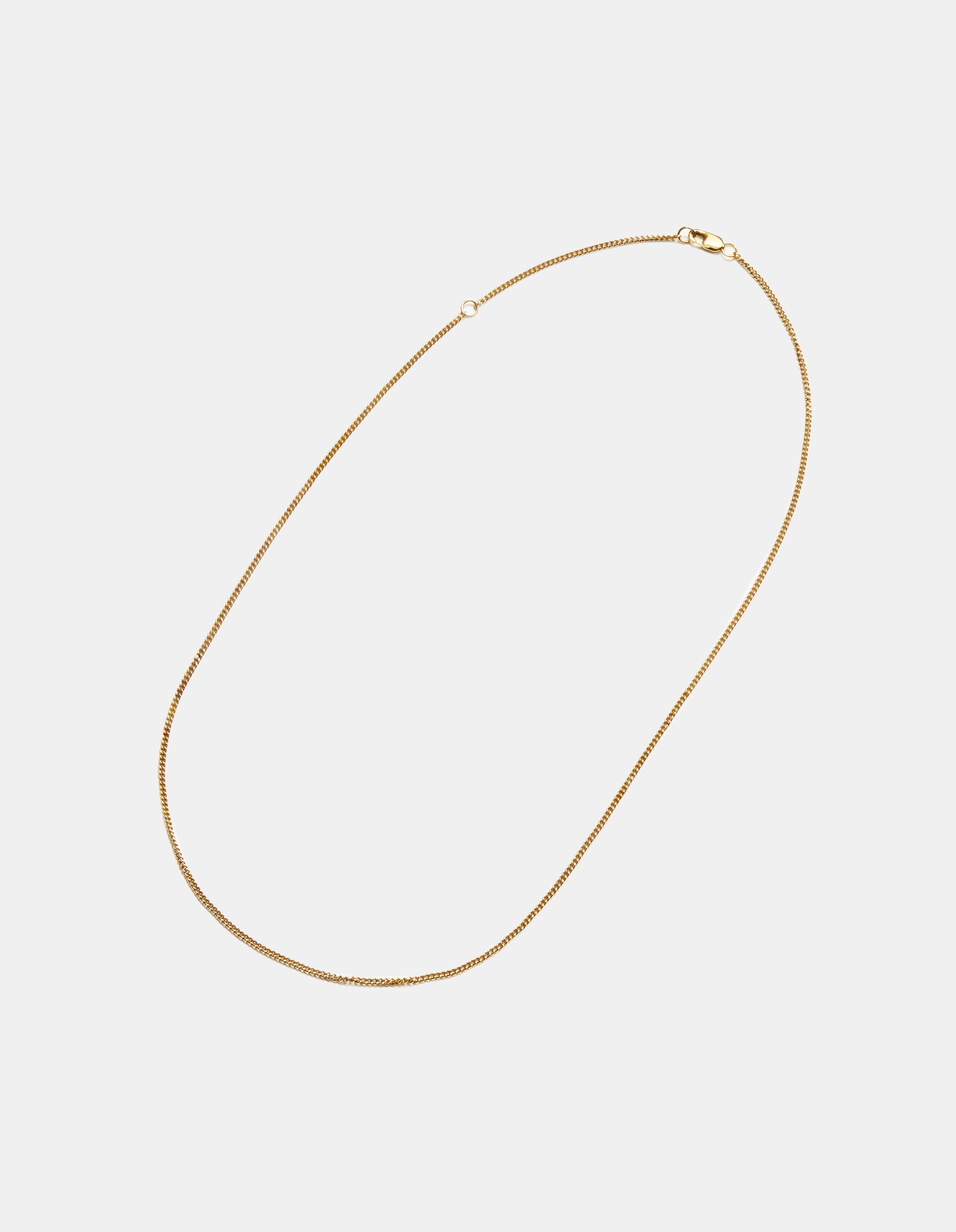 The Shinola Small Curb Link necklace features a thin, small 14k yellow gold curb chain with a discreet clasp, shown on a plain white background.