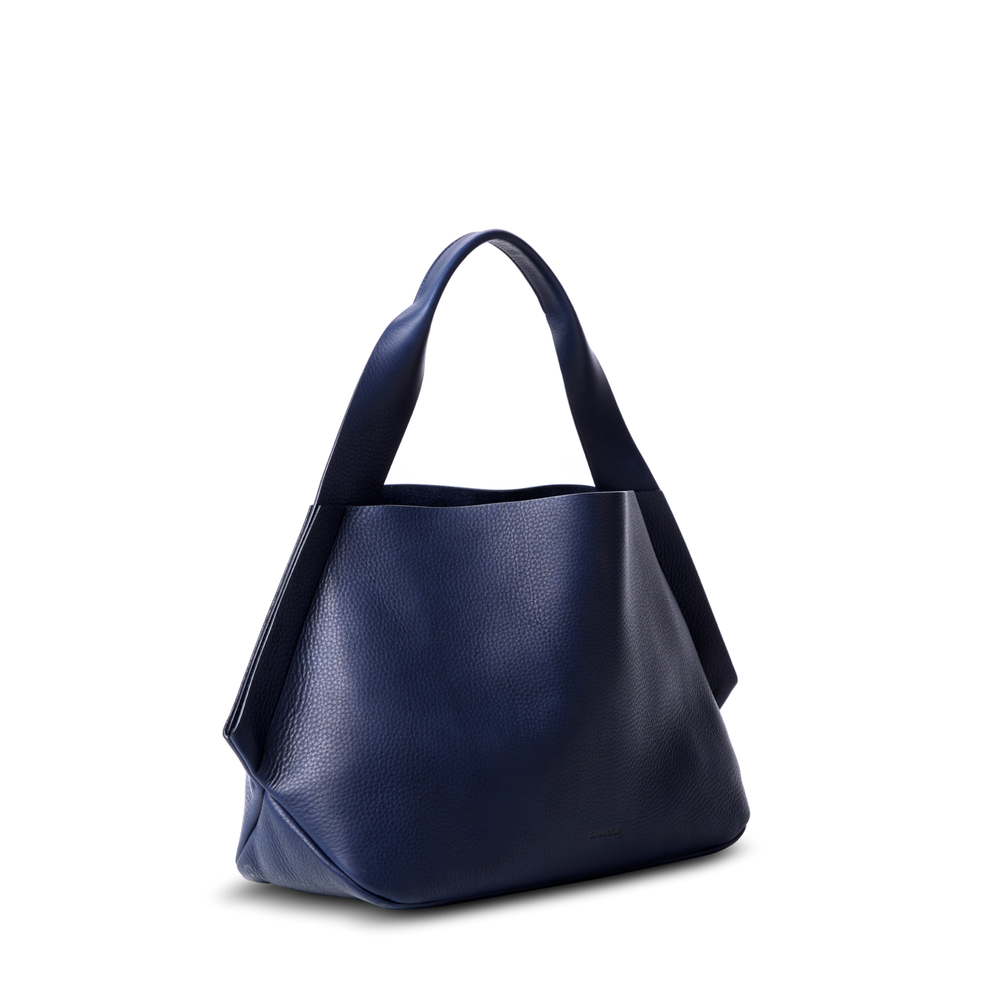 The Shinola Runwell Shoulder Bag - Lake is a spacious, navy blue textured leather bag with wide handles and a leather card pocket, shown against a plain white background.