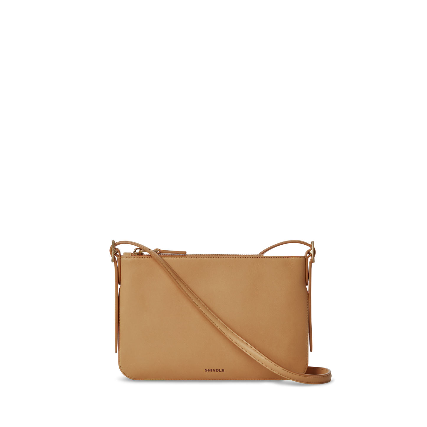 The Small Bixby Crossbody - Honey by Shinola features natural tan leather, a zippered top, adjustable strap, and simple design. "Shinola" is embossed near the bottom and it's shown against a plain white background—perfect for daily use.