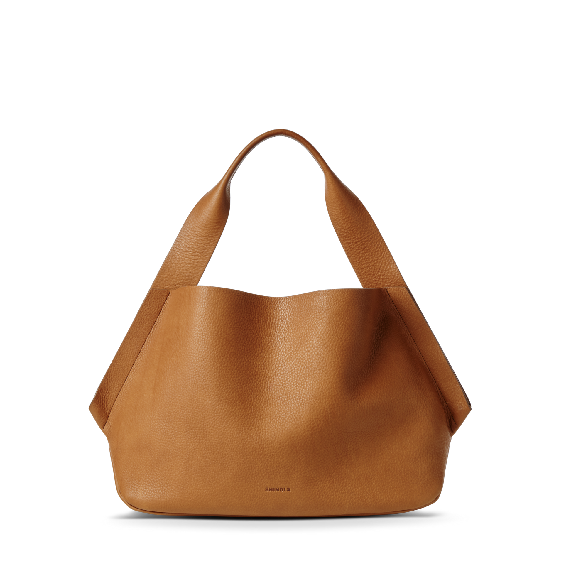 The Shinola Derby Shoulder Bag - Tan is a large tote with wide handles, a minimal unstructured silhouette, and a discreet leather card pocket, shown standing upright against a white background.