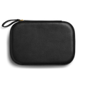 The Shinola Travel Jewelry Case - Black is a rectangular leather case with rounded edges, a wrist strap, and zippered closure, displayed against a plain white background.