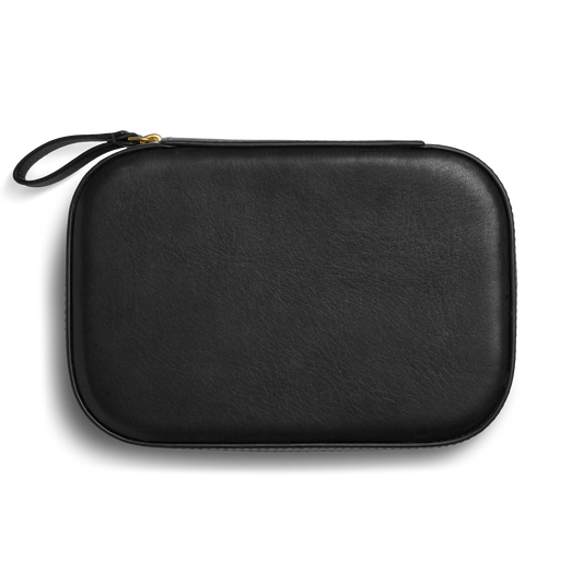 The Shinola Travel Jewelry Case - Black is a rectangular leather case with rounded edges, a wrist strap, and zippered closure, displayed against a plain white background.
