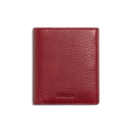 A closed Coin Bifold - Ruby wallet by Shinola, crafted from natural grain leather with a textured finish and embossed branding at the bottom, shown on a plain white background.