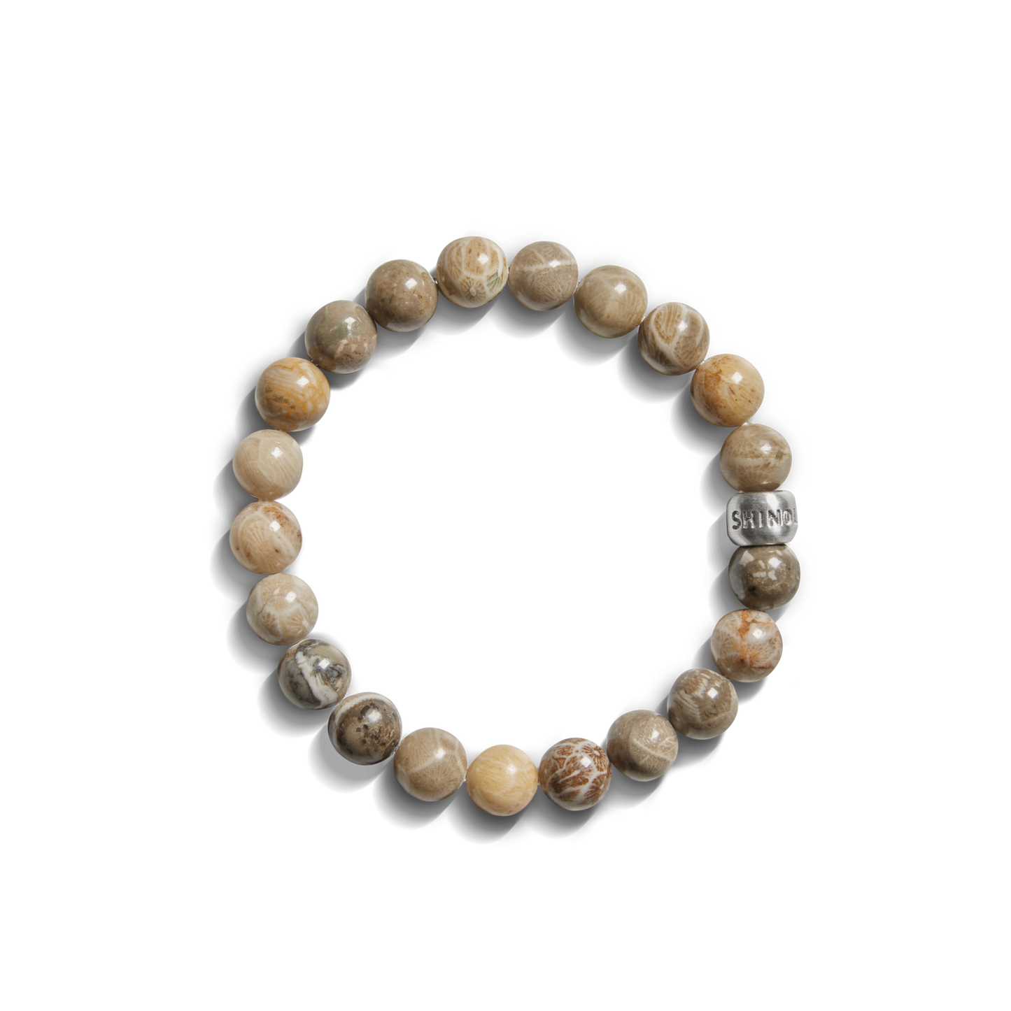 The Shinola 8mm Beaded Petoskey Bracelet features polished brown and beige Petoskey stone beads and a sterling silver “SAINT” bead—a distinctive Michigan jewelry piece.