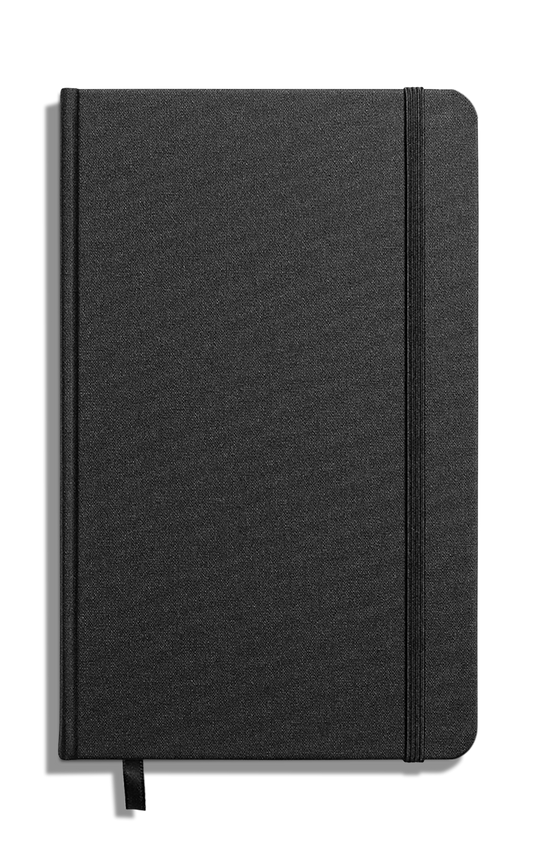 The Shinola Medium Hard Plain Journal in black features a textured linen cover, right-side elastic band, bottom ribbon bookmark, and acid-free paper. Displayed against a white background.