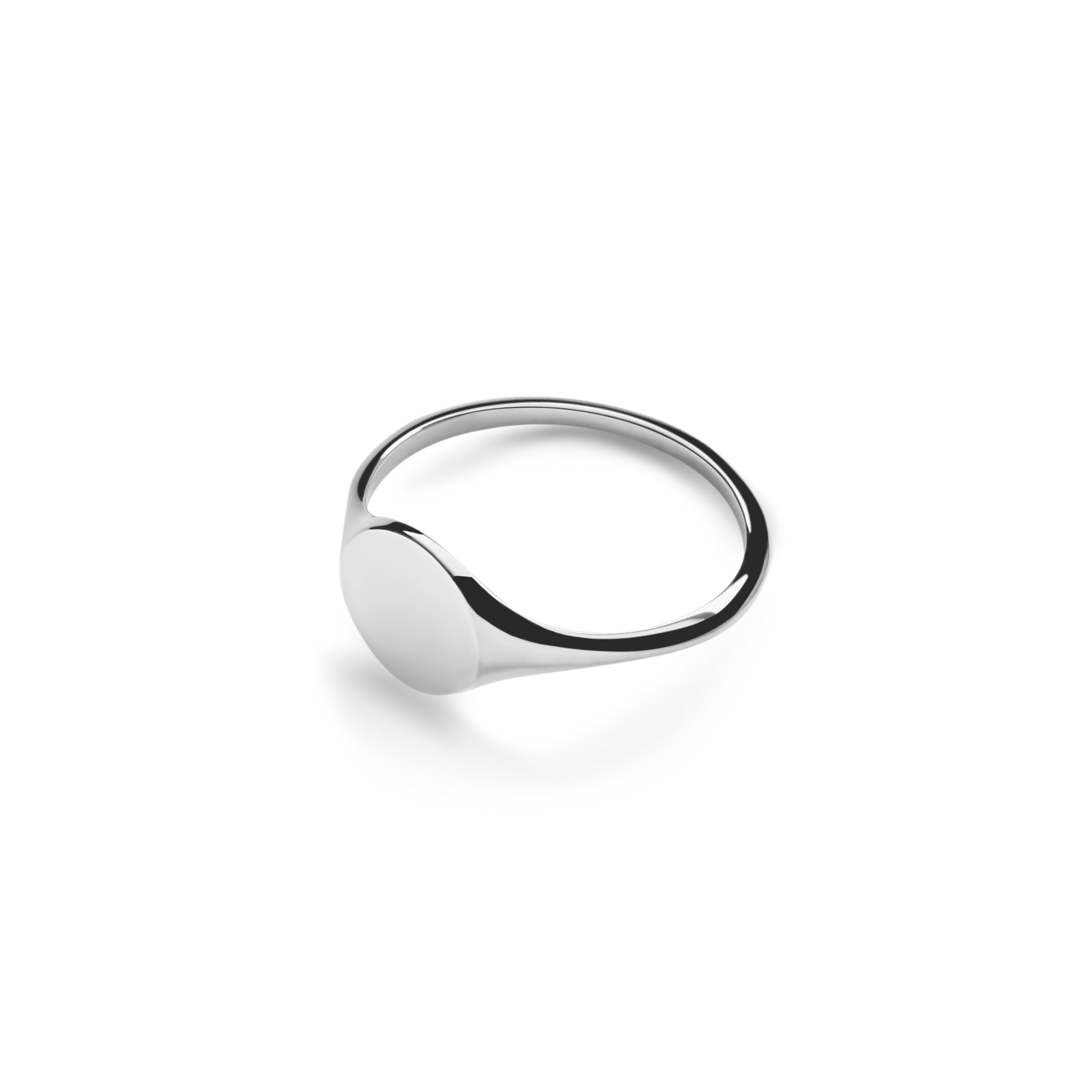 The Shinola Petite Round Signet Ring in sterling silver features a smooth, flat face and timeless minimalist style, shown against a white background.