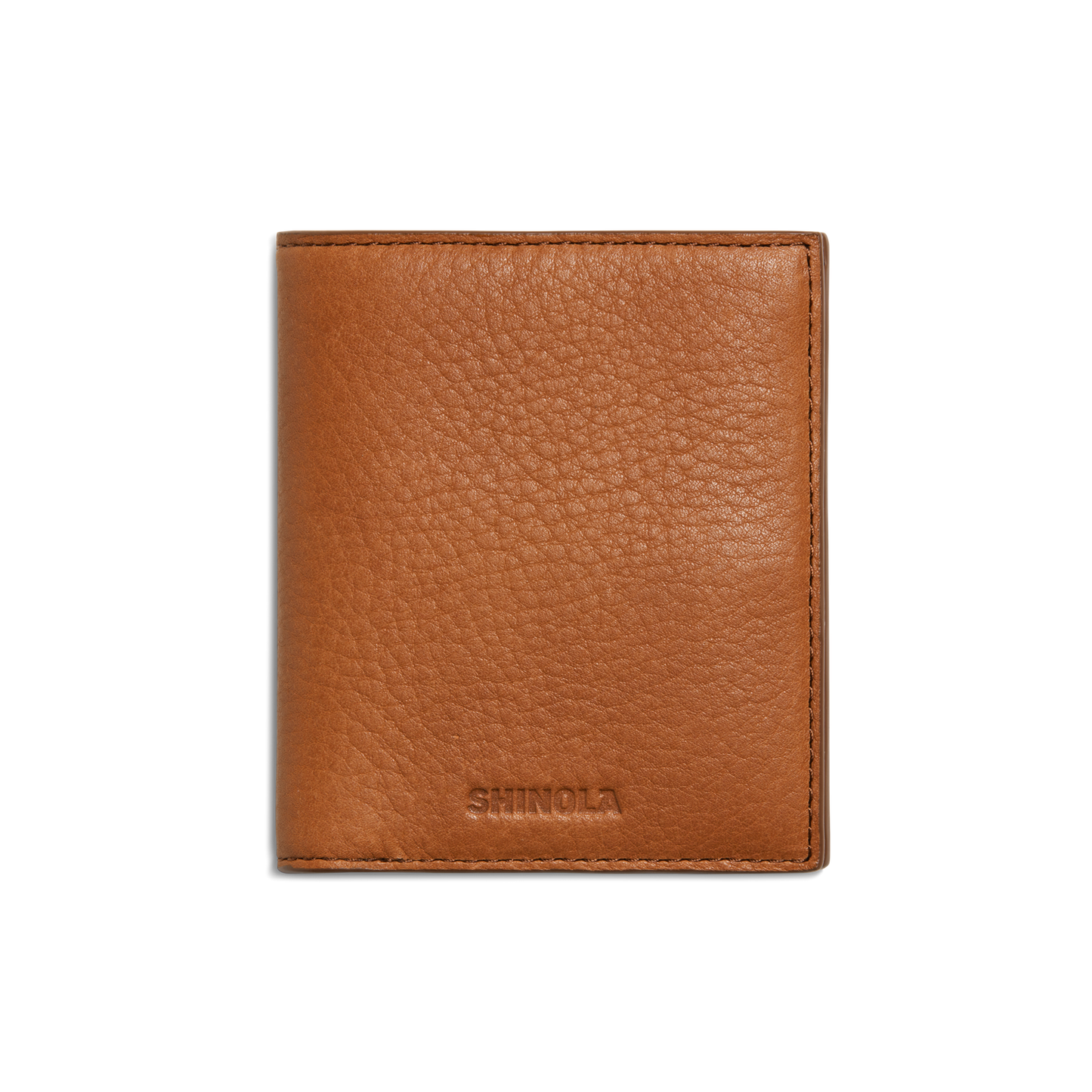 The Shinola Coin Bifold - Tan is a slim, textured natural grain leather wallet with SHINOLA embossed near the bottom center, shown closed on a plain white background. It offers refined style and lasting durability.