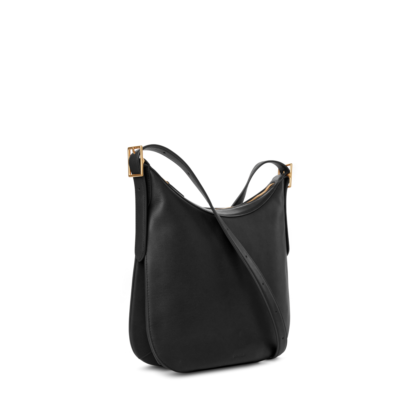 The Medium Bixby Crossbody - Black by Shinola is a minimalist natural leather shoulder bag with dual slim straps and gold-tone rectangular buckles, shown on a plain white background for versatile styling.