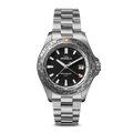 The Shinola Monster Worldtimer GMT Watch features a black dial, silver hour markers, date window at 3 o’clock, world timer bezel with cities, orange GMT hand, and a metal link band—perfect for travelers.