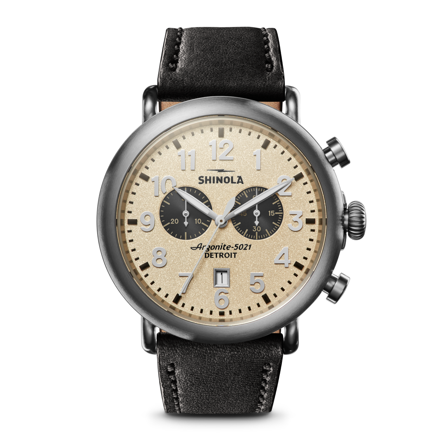 The Shinola Runwell Chronograph - Cream features a beige dial, black subdials, stainless steel case, black leather strap, Arabic numerals, two chronograph dials, and prominent pushers on the right.