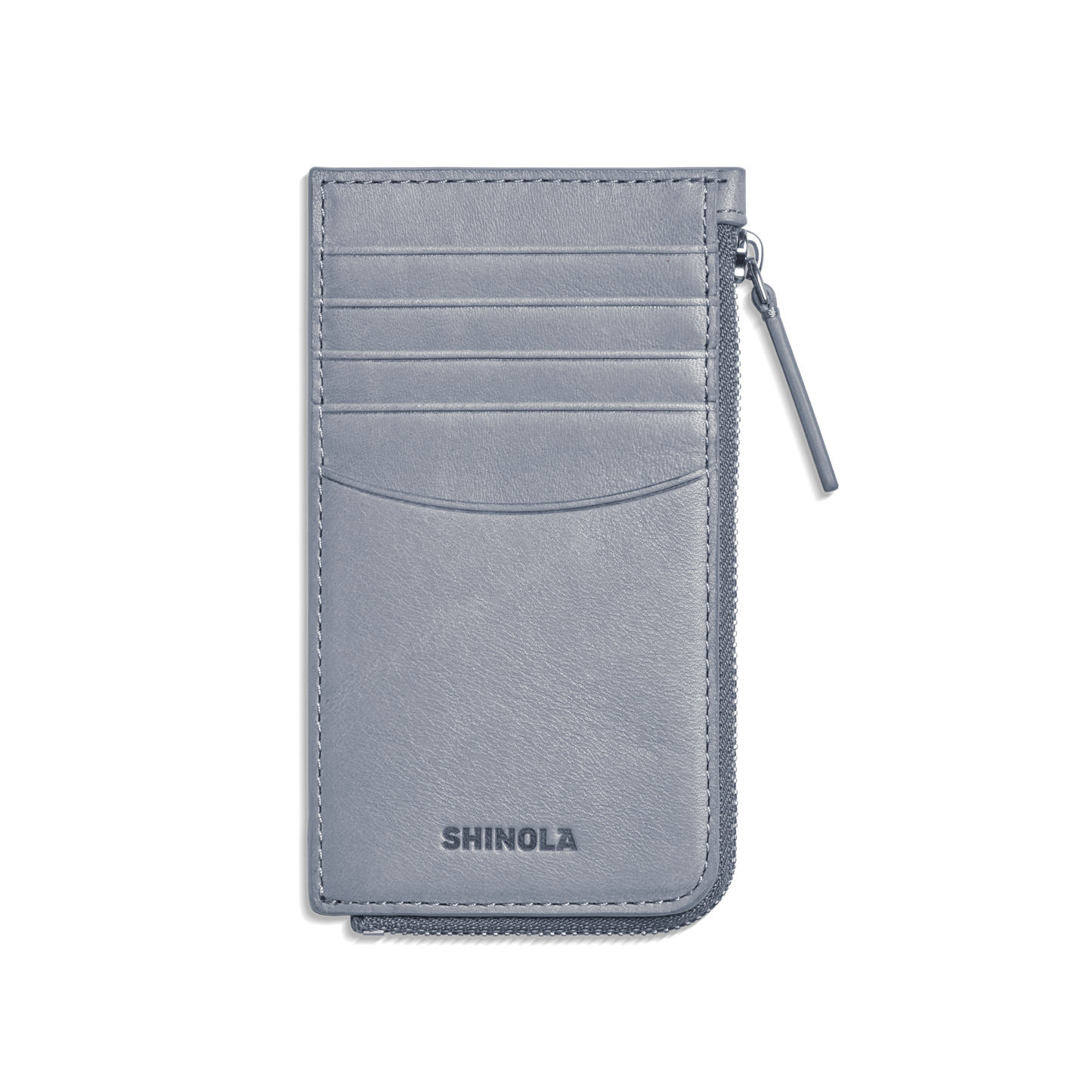 The Zip Around Card Case - Mist by Shinola is a slim, light gray leather case with five card pockets, a right-side zippered pocket, and the Shinola name embossed at the bottom.