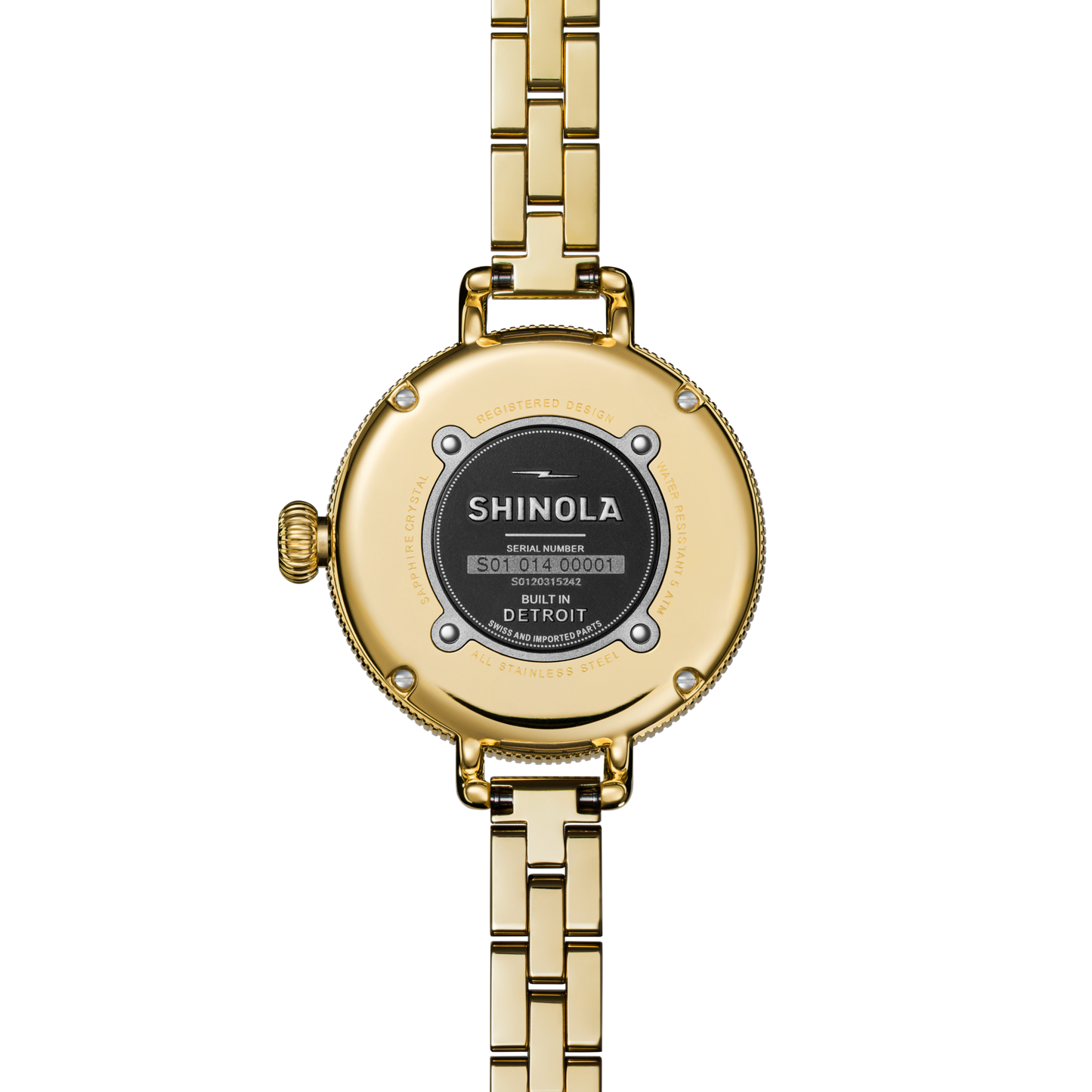 Close-up of the Shinola Birdy Watch - Lapis (gold, metal link band), showing the back with brand, serial number, "Built in Detroit" text, and four visible screws.