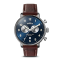 The Shinola Canfield Chronograph Watch with a blue dial, white markers, two silver subdials, and a cattail leather strap features top-loaded case construction against a white background.