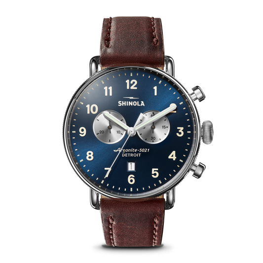 The Shinola Canfield Chronograph Watch with a blue dial, white markers, two silver subdials, and a cattail leather strap features top-loaded case construction against a white background.