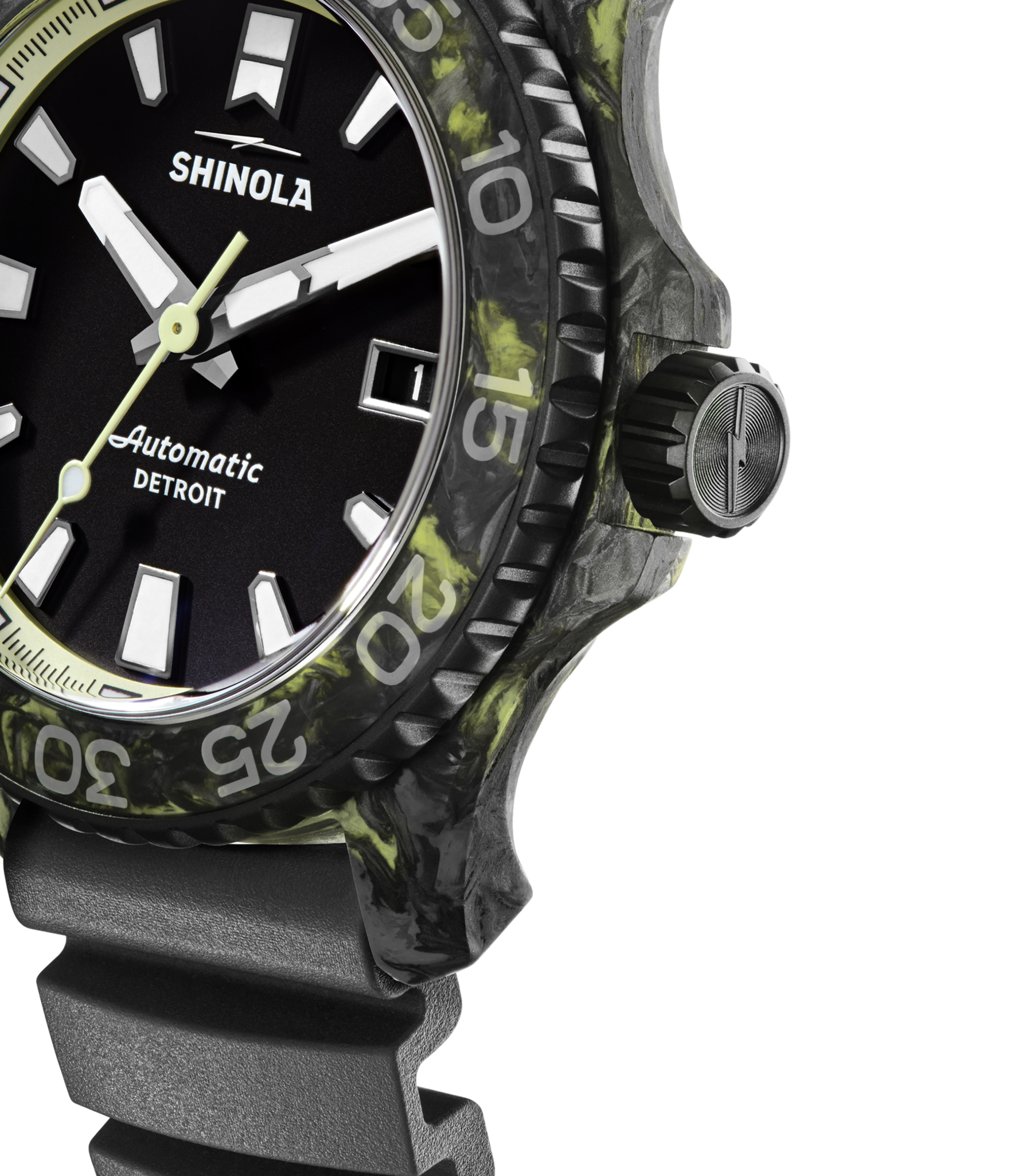 Close-up of the Shinola Forged Carbon Monster Watch featuring a forged carbon case, black and green marbled bezel, black dial with bold white hour markers, black ridged strap, and DETROIT visible on the face.