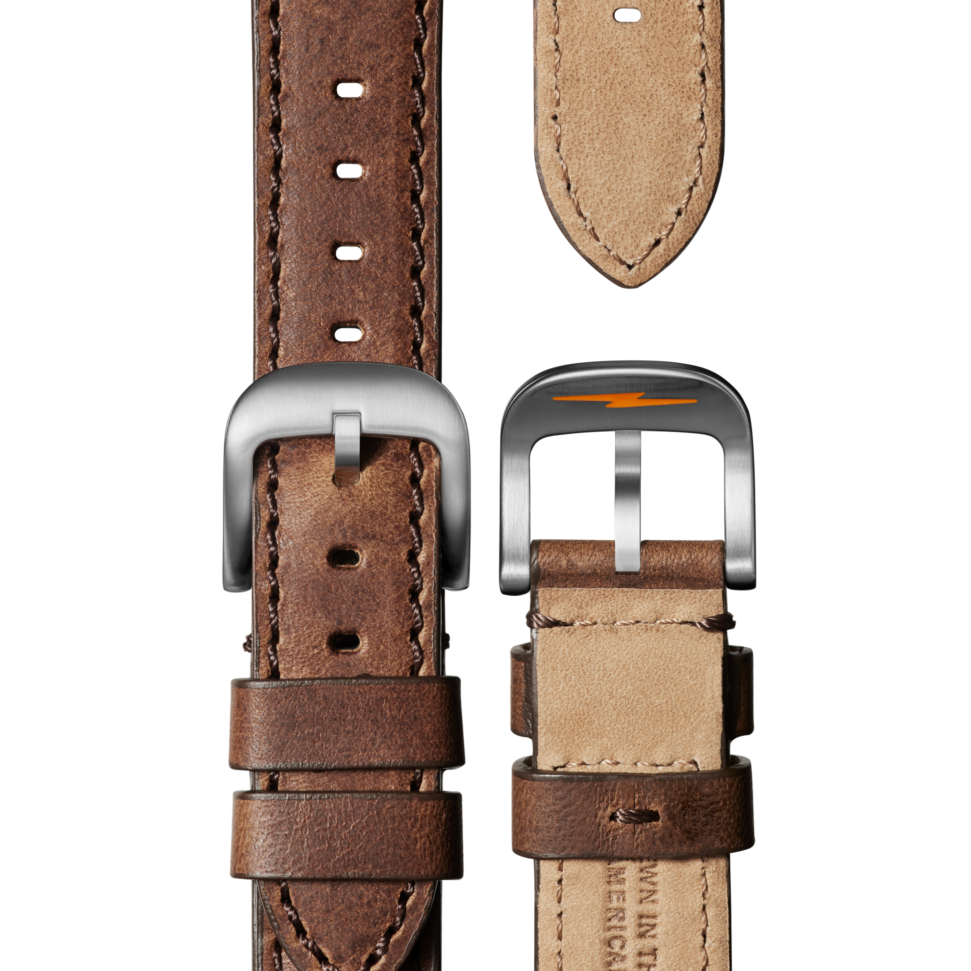 Two brown leather straps for the Shinola Runwell Chronograph Watch - Black are shown from above: one with a silver buckle and visible stitching, the other showing the underside and buckle with an orange lightning bolt detail.