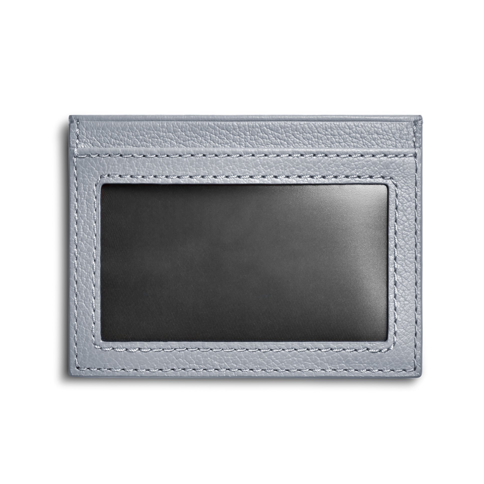 The Shinola Canfield ID Card Holder in Mist is a light gray pebbled leather wallet featuring a clear window for displaying an ID or card, shown against a plain white background.