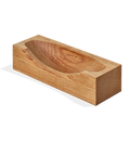The Shinola Clock Stand - Natural Oak is a handcrafted rectangular block with a shallow oval top indentation, reflecting elegant design details, shown against a plain white background.
