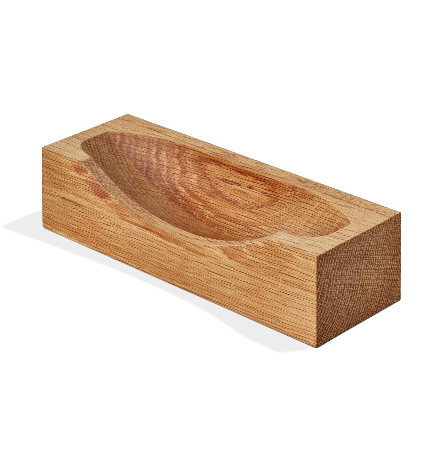 The Shinola Clock Stand - Natural Oak is a handcrafted rectangular block with a shallow oval top indentation, reflecting elegant design details, shown against a plain white background.
